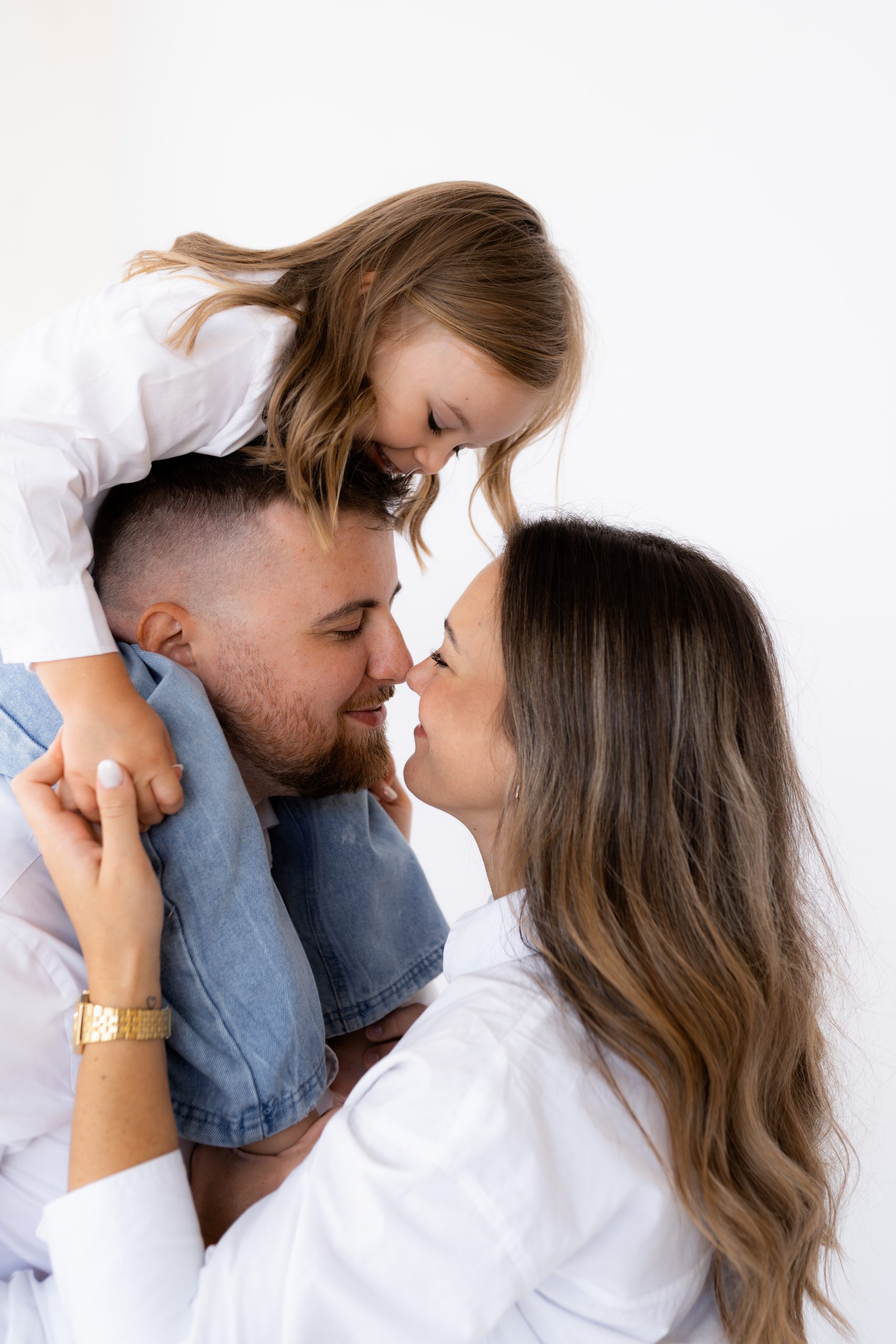 Rodinné focení v ateliéru HLight Studio. Fotograf Lukáš Vavřinec zachytil láskyplný okamžik mezi rodiči a jejich dcerou.
